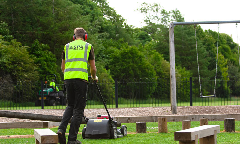 landscaping contractors grass cutting on play area in Sheffield, South Yorkshire